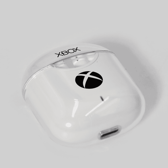 A pair of white earphones in a clear case, featuring a logo on the front.