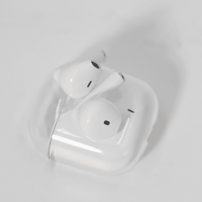 White noise cancellation earbuds in a clear case, featuring a simple design and a compact size.