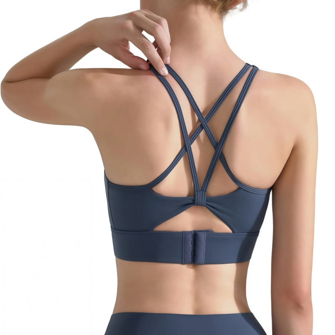 A women's navy cross back yoga crop bra tank with multi-strapped back design and adjustable closure.
