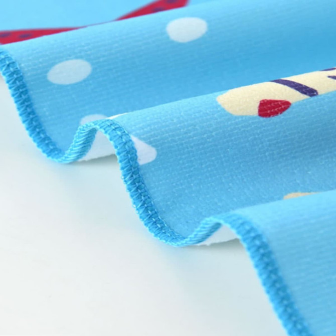 A blue microfibre towel featuring colourful patterns and a logo, with a soft, textured edge.