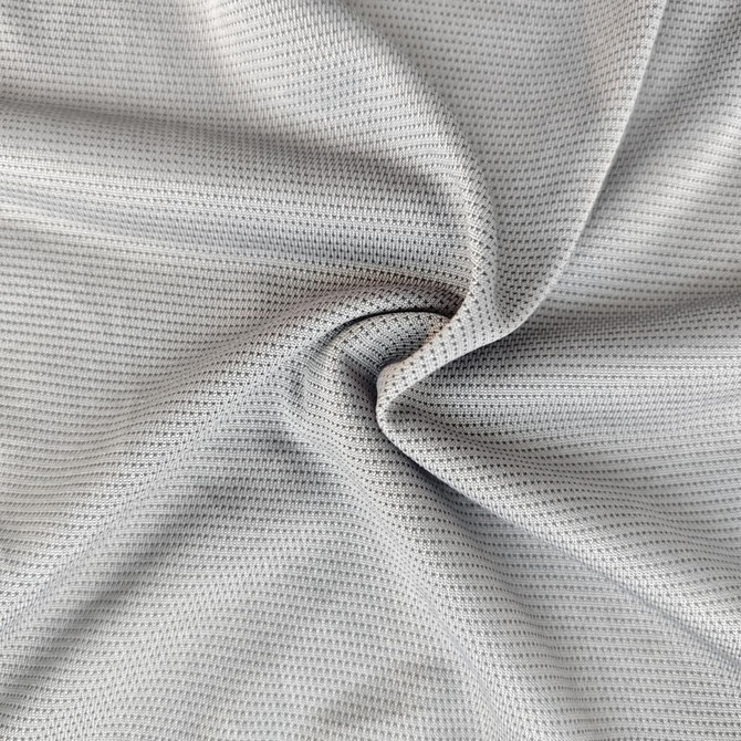 A close-up view of soft, breathable fabric in grey with a mesh texture, ideal for clothing.