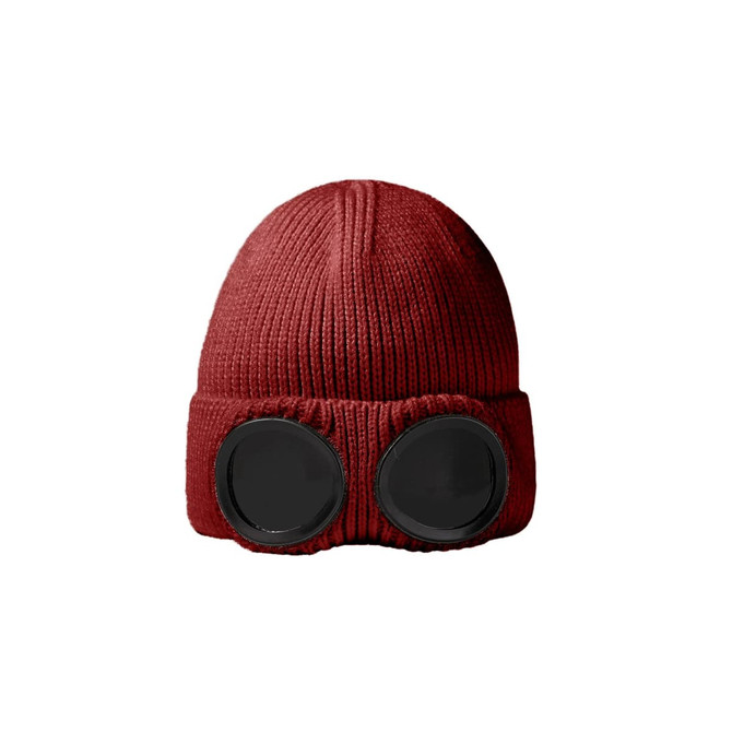 A red beanie featuring large black goggles on the front, with a ribbed texture throughout.