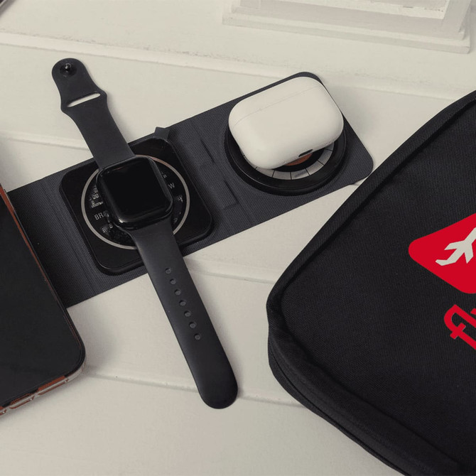 A black tech kit featuring a smartwatch, wireless earbuds case, and space for a smartphone. Includes a branded logo.