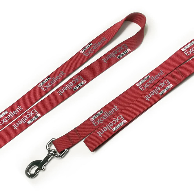 A red polyester dog leash with a shiny metal clip and branding throughout its length.