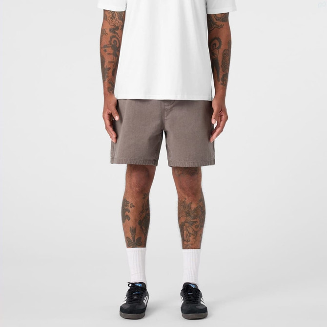 Faded walk shorts in brown, featuring a relaxed fit, worn with a white t-shirt and black sneakers.
