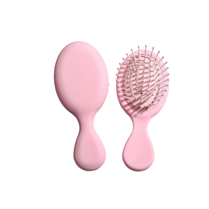 A pink mini paddle brush with a smooth handle and rounded bristles, featuring a simple design.