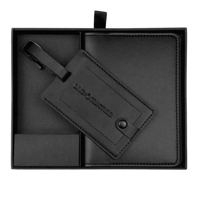 A black travel gift set featuring a luggage tag and a matching holder, neatly presented in a box.