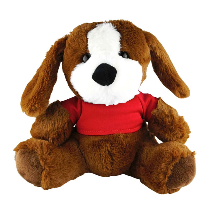 A brown plush dog with floppy ears wearing a red shirt, seated and looking forward. It has a soft, fluffy texture.