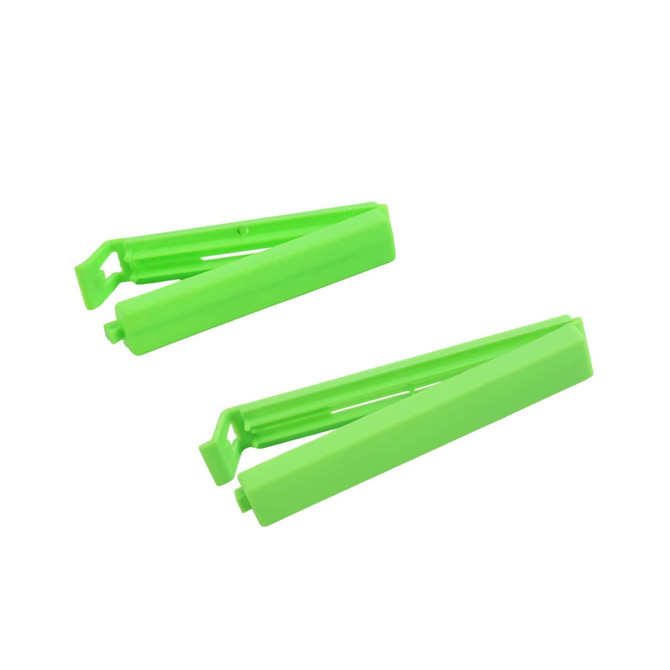 Two bright green medium food bag seal clips positioned side by side, featuring a simple design and a small logo.