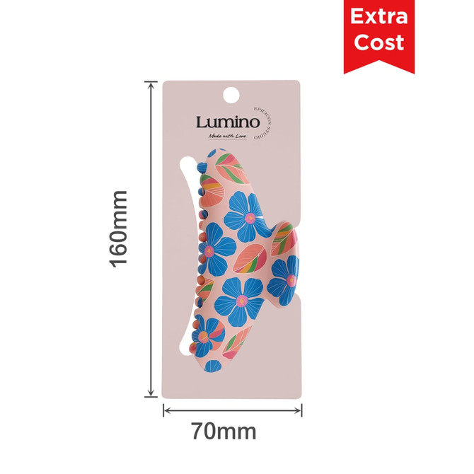 A floral print hair clip featuring blue flowers on a pink background, displayed on a card with a logo.