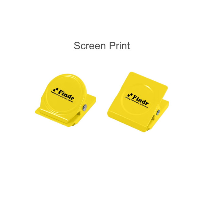 A pair of bright yellow metal magnetic clips with a logo, one circular and one rectangular.