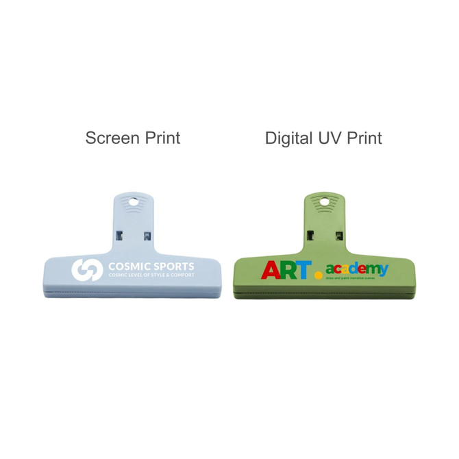 Two plastic magnetic clips in blue and green, featuring different designs and print styles. Each has a logo.