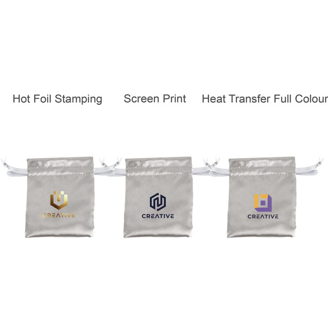 Three silk satin drawstring bags in silver, featuring different logo designs. Each bag has a white drawstring.