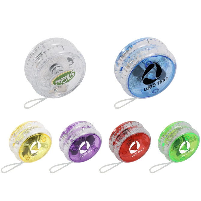 A collection of light-up yoyos in clear, yellow, purple, red, and green, featuring logos and a string attachment.