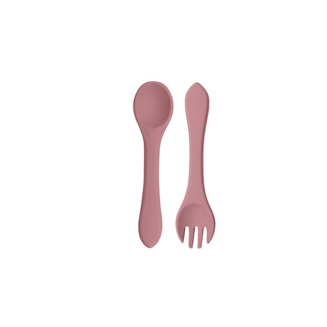 A set of classic silicone kids cutlery in a soft pink colour, including a spoon and a fork. The utensils have a smooth design and are flexible.