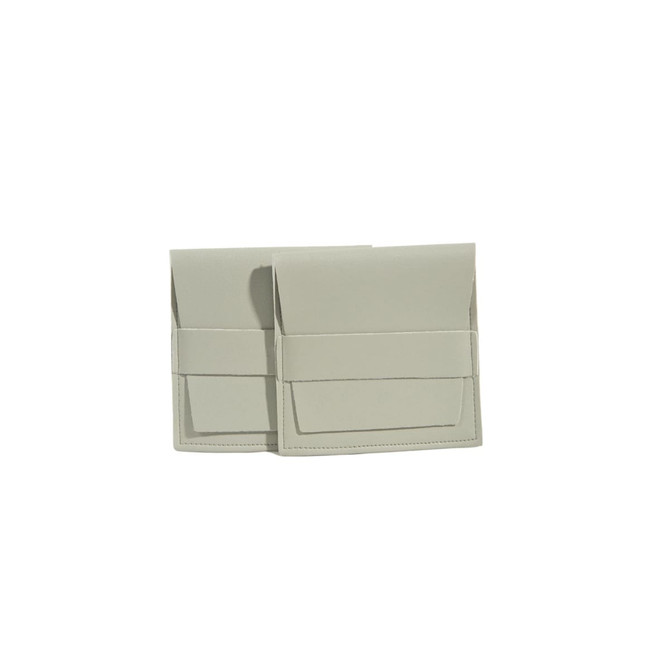 A PU leather flip jewelry pouch in a soft grey colour, featuring a flap closure and a logo on the front.