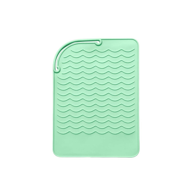 A mint green silicone pad featuring a wavy texture and a loop for hanging. It has a branding logo.