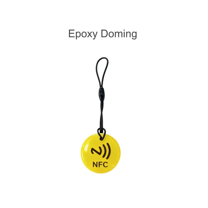 A yellow round NFC tag with a black strap, featuring an icon and a logo.