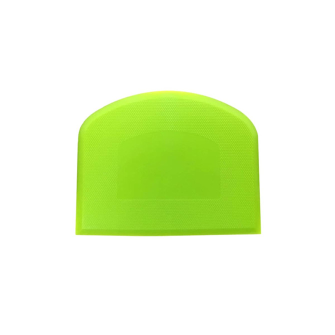 A flexible bowl scraper in bright yellow-green, featuring a textured surface and a rounded top edge, with a logo present.