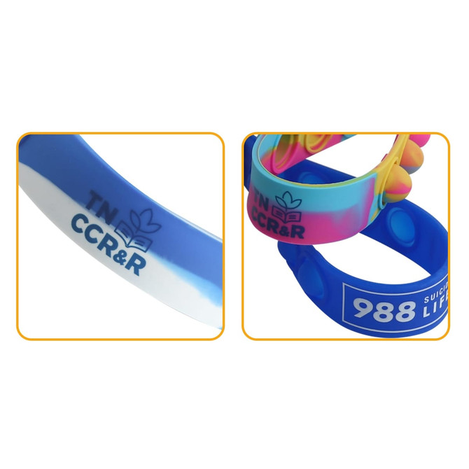 Colourful silicone wristbands with varied designs, featuring different blue shades and a logo.