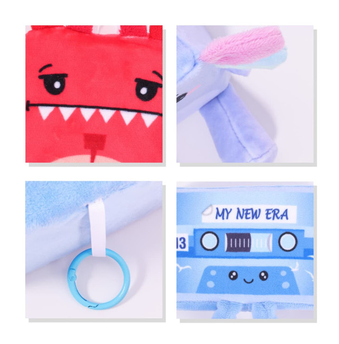 A red and blue plush toy with a cartoon face, featuring an O ring attachment. Includes a logo or branding element.