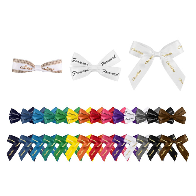 A collection of hair clip bows in various colours, including white, blue, green, and red, with some featuring patterns and text.