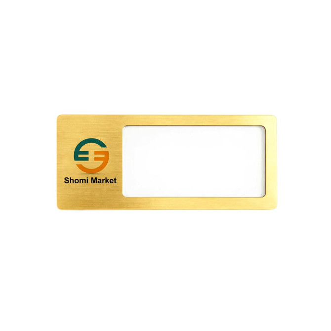 A rectangular reusable metal name badge in gold with a window for a name and a logo in the corner.