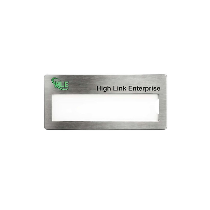 A silver metal name badge with a blank area for a name and a logo in one corner.