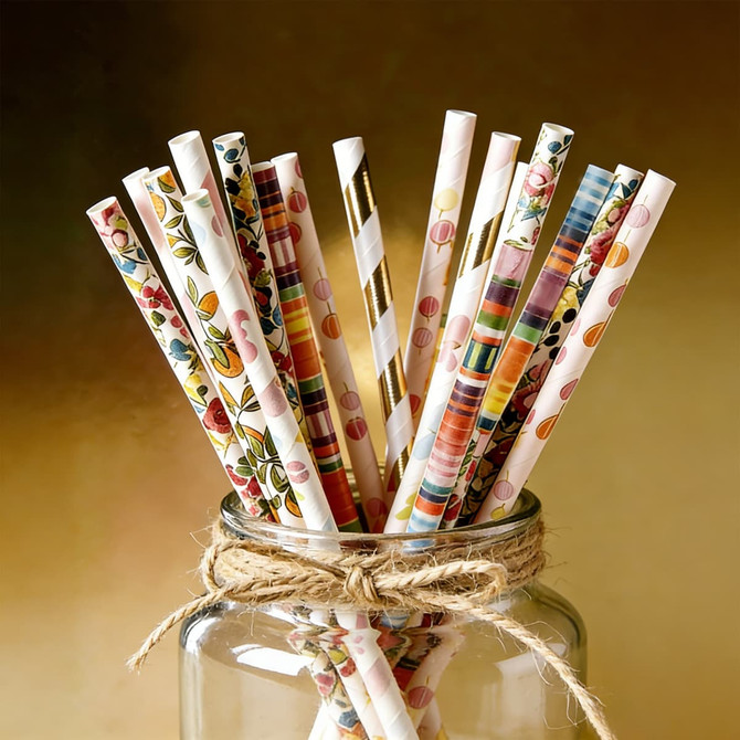 A jar filled with colourful, patterned disposable 4-ply paper straws featuring various designs and colours.