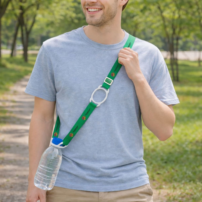 A drink bottle with a green lanyard strap is being worn by a man walking in a park. The lanyard features a logo.