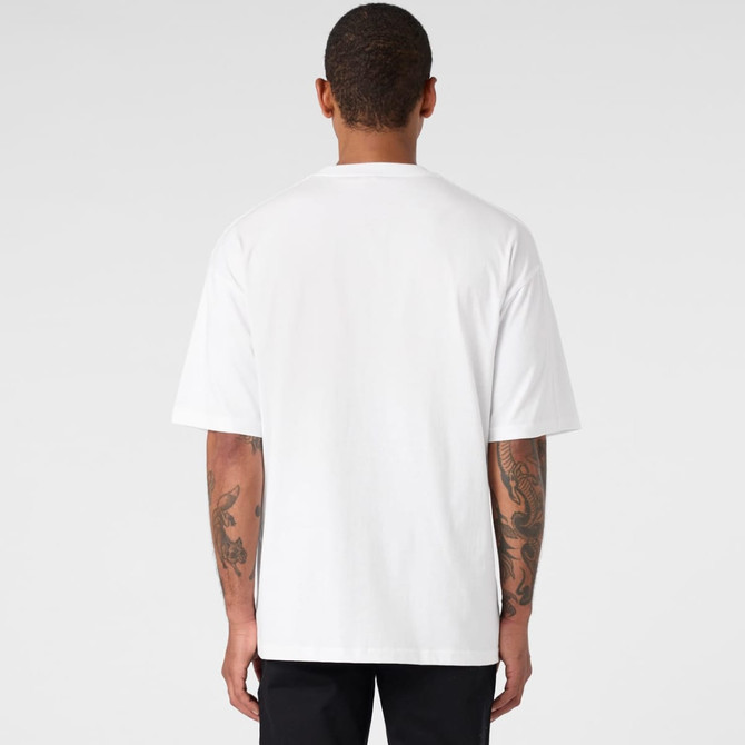 A person wearing a white oversized tee, showing the back view and featuring a logo on the neck area.