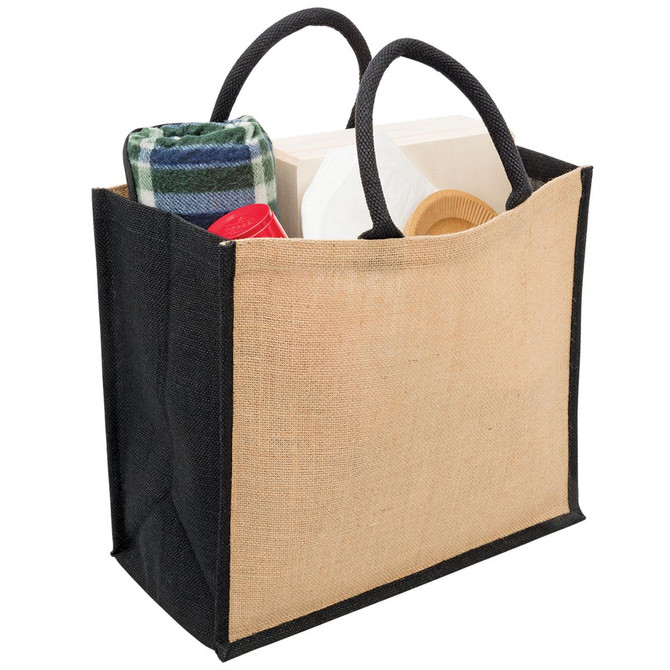 A jute tote bag with wide gusset, featuring black sides and a natural beige centre, filled with a blanket and other items.