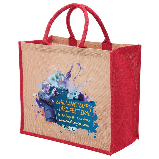 A jute tote bag with a wide gusset featuring red handles and a vibrant printed design on one side.