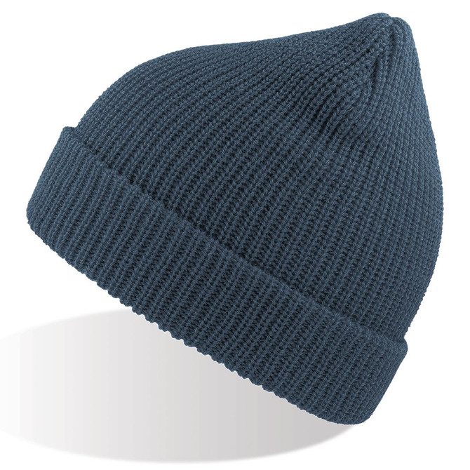 A woolly beanie in a deep blue colour, featuring a ribbed texture and a folded cuff. It has a logo visible.