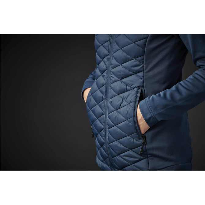 A navy blue women's thermal shell jacket featuring a quilted pattern and side pockets. Includes a subtle logo.