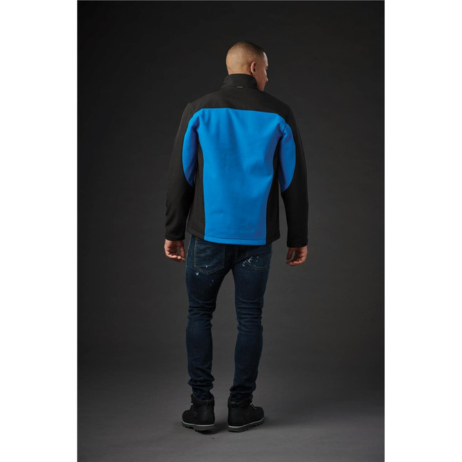 A men's softshell jacket in black and blue, featuring a logo, shown from the back on a model.