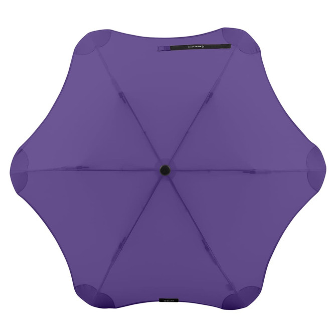 A purple BLUNT Metro Umbrella with a unique design and a central button for opening and closing.