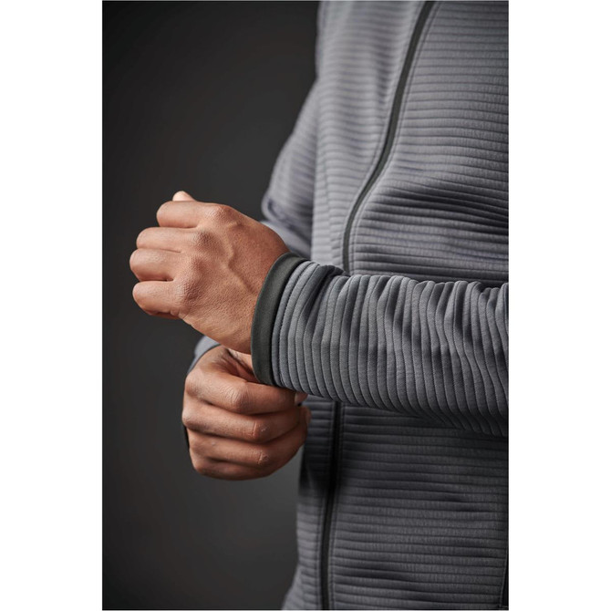 A close-up of a grey Men's Andorra Jacket, featuring ribbed fabric and a zip-up front, with a person's hand adjusting the cuff.