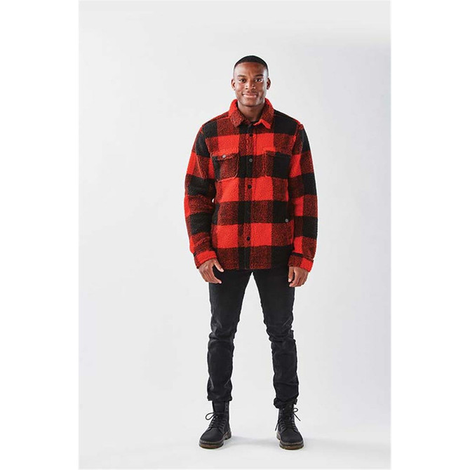 A unisex red and black check fleece jacket with a collar and front buttons, worn by a model standing.