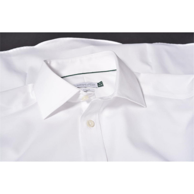 A white button-up shirt with a collar, featuring a branded label inside the neckline.