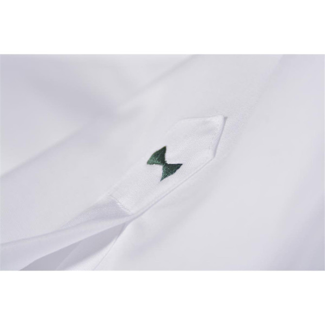 A white button-up shirt featuring a green bow emblem on the collar. It has a logo present.
