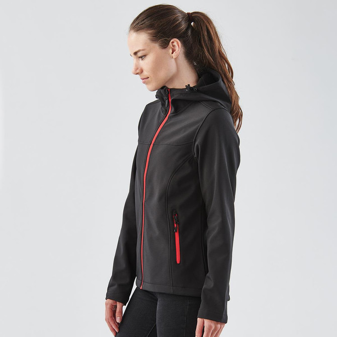 A black softshell hoody with red zippers and a hood, featuring a logo on the chest.