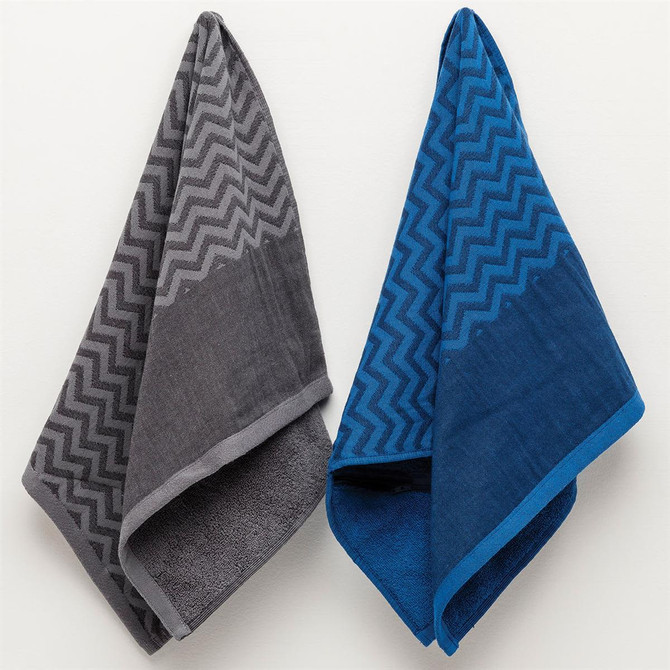 Two gym towels in grey and blue, featuring a zigzag pattern and a hanging pocket for convenience. Each towel has a logo.