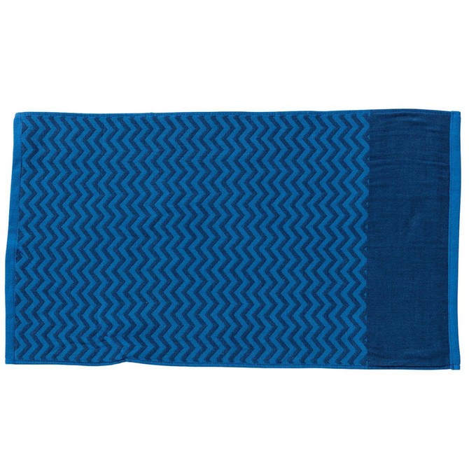 A blue gym towel with a patterned design and a pocket on one side. It features a logo.
