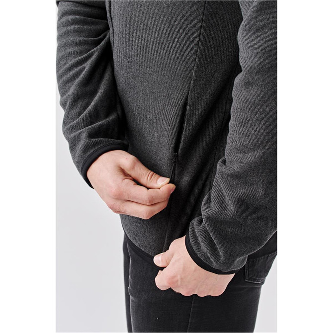 A men's full zip jacket in dark grey, featuring a zippered pocket and fitted cuffs. Includes a logo.