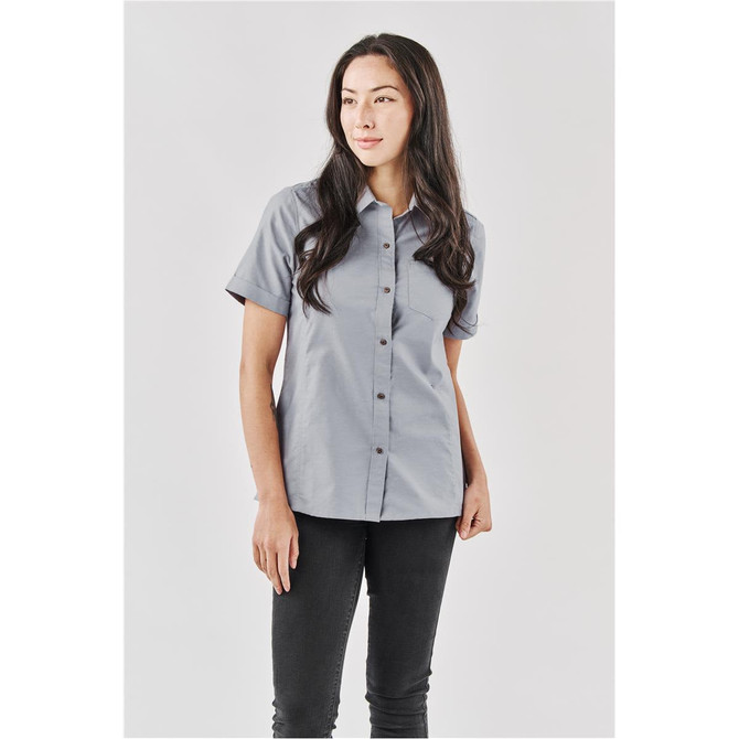 A short-sleeved women's button-up shirt in light grey, featuring a fitted design and a logo.