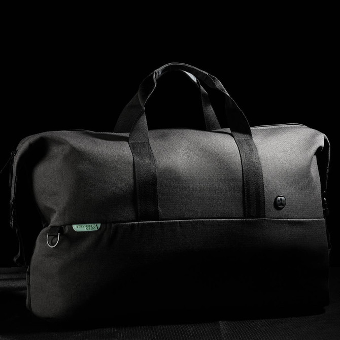 A black duffle bag with dual handles and a logo, featuring a sleek design and spacious interior.