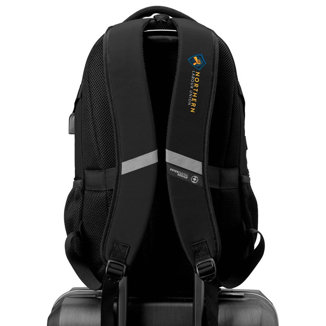 A black Swissdigital Vector Backpack featuring padded straps and a logo, resting on a suitcase.