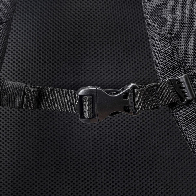 A close-up of a black adjustable buckle on a mesh-backed backpack. The texture is visible.