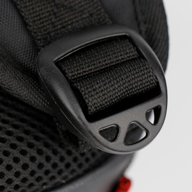 A close-up of a black strap buckle from the Swissdigital Pixel Backpack, featuring textured fabric and a mesh design.